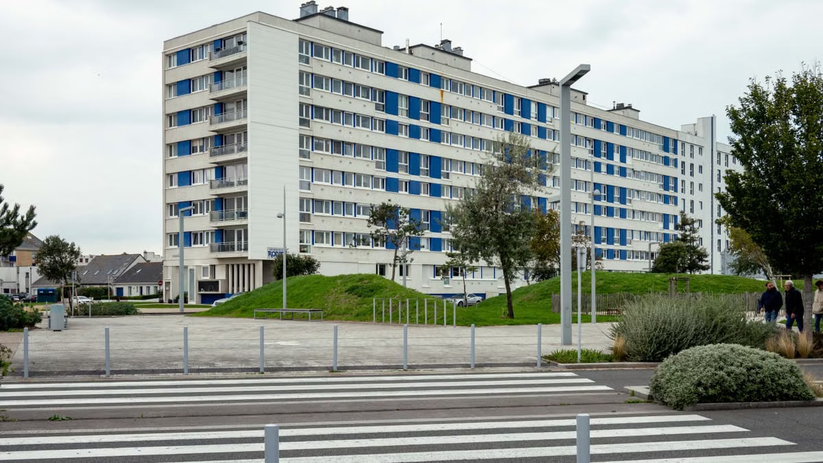Modern apartment building with greenery in Calais, France, highlighting urban living.